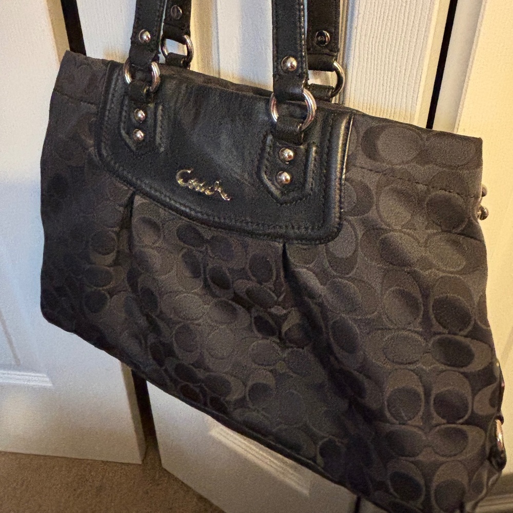 Coach handbag. Canvas with leather trim and silver hardware.